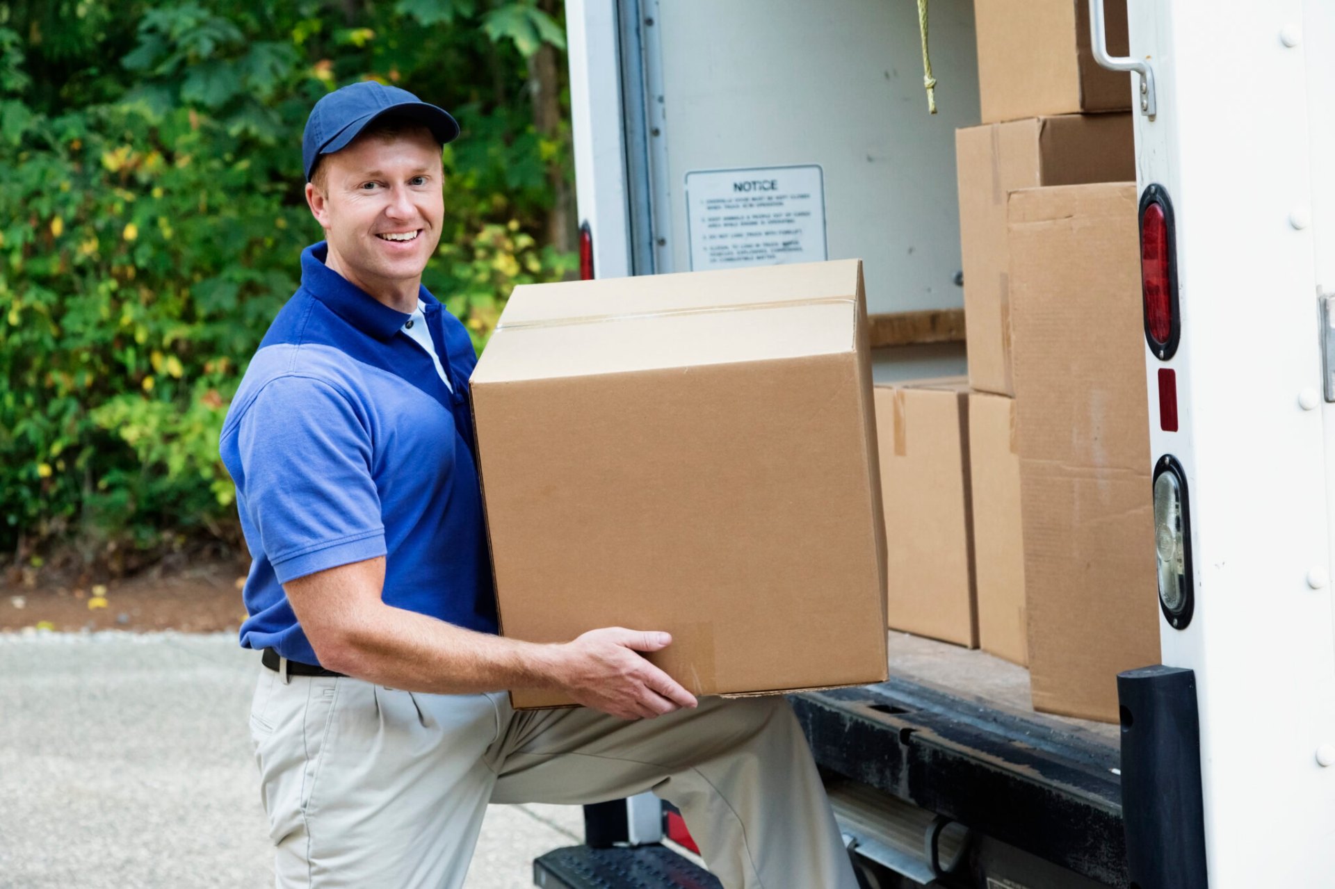 Professional mover loading boxes into truck